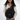 Person placing a passport inside a Sherpani Esprit Raven Black Sling Bag.