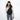 Woman wearing a Sherpani Esprit Raven Black Sling on her front against white backdrop. #color_raven-black