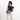 Woman holding a Sherpani Co-Pilot Houndstooth Travel Toiletry Case against white backdrop. #color_houndstooth-print
