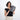 Woman holding a Sherpani Co-Pilot Houndstooth Travel Toiletry Case against white backdrop. #color_houndstooth-print
