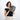 Woman holding a Sherpani Co-Pilot Houndstooth Travel Toiletry Case against white backdrop. #color_houndstooth-print