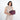 Woman holding a Sherpani Co-Pilot Smoky Orchid Travel Toiletry Case against white backdrop. #color_smoky-orchid-pink