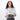 Woman holding a Sherpani Mini Co-Pilot Granite Grey Mini Travel Organizer against white backdrop. #color_granite-grey