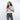Woman holding a Sherpani Barcelona Carbon Black Anti-Theft Mini Wallet on white backdrop.  #color_carbon-black