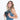 Woman holds a Sherpani Tulum Chromatic Black RFID Wallet with passport inside against white background. #color_chromatic-black