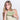 Woman holds a Sherpani Tulum Palm Green RFID Wallet against white background.  #color_palm-green