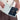 A woman holding a Sherpani Vienna Straw Beige Anti-theft Passport Wallet against a white background.  #color_straw-beige